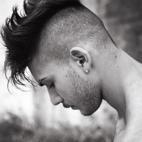 a textured mohawk haircut with hair on the sides that feature the buzz cut and the top is layered