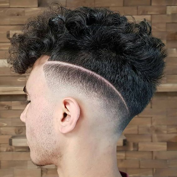 a mid fade curly haircut is a daring and bold option to rock