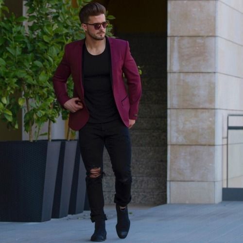 a total black look with ripped jeans and a plum-colored blazer for a colorful touch