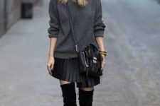 With black hat, gray sweater, black crossbody bag and over the knee boots