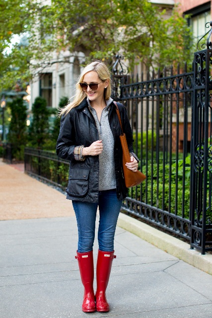 With black jacket, brown tote, jeans and red high boots