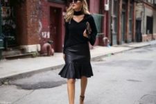 With black leather skirt, high heels, clutch and sunglasses