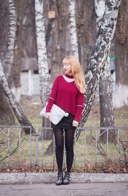 With black mini skirt, fur clutch, black tights and embellished boots