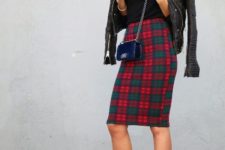 With black shirt, black leather jacket, navy blue mini bag and white high heels