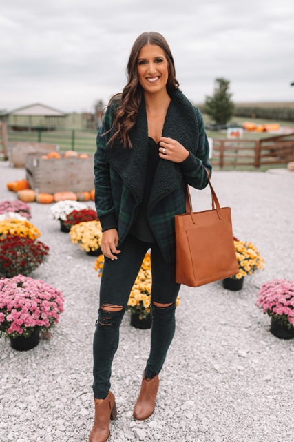 With black top, distressed skinny pants, brown leather ankle boots and brown leather tote