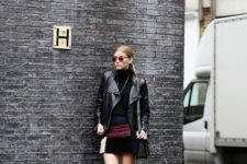With black turtleneck, black leather jacket, ankle boots and bag