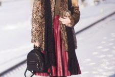 With brown turtleneck, leopard coat, black backpack, black scarf and lace up boots