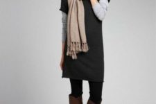 With gray shirt, beige scarf, black tights and brown leather high boots