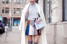 With gray sweater, white coat, light blue bag and gray boots