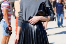 With gray sweatshirt and black clutch