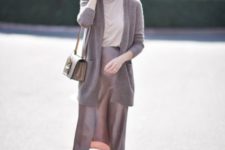 With pastel colored shirt, gray cardigan, gray bag and mules