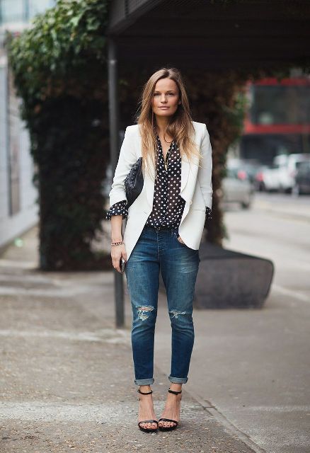 With polka dot blouse, cuffed jeans and high heels