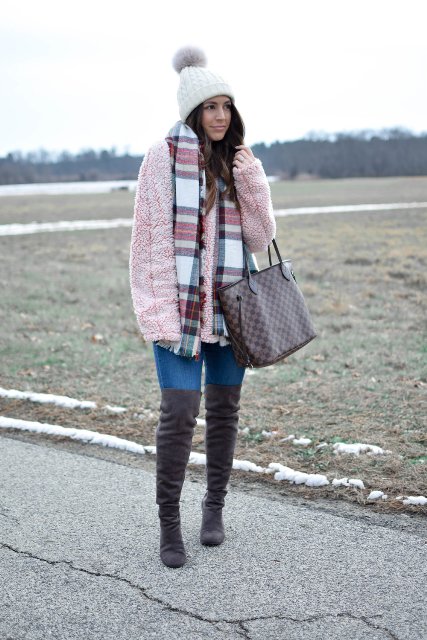 With pom pom hat, plaid scarf, jeans, gray over the knee boots and printed tote