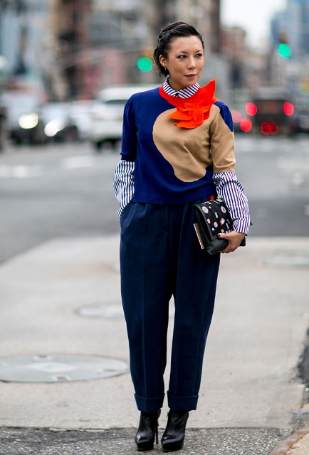 With striped shirt, embellished clutch, navy blue trousers and platform boots