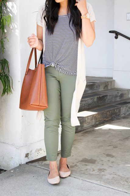 With striped t-shirt, olive green pants, flats and brown bag