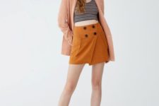 With striped top, peach cardigan, lace up boots and cap