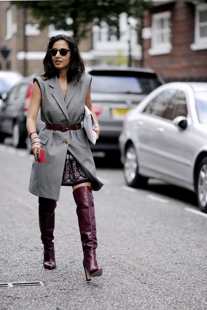 With top, printed skirt, over the knee boots and white clutch