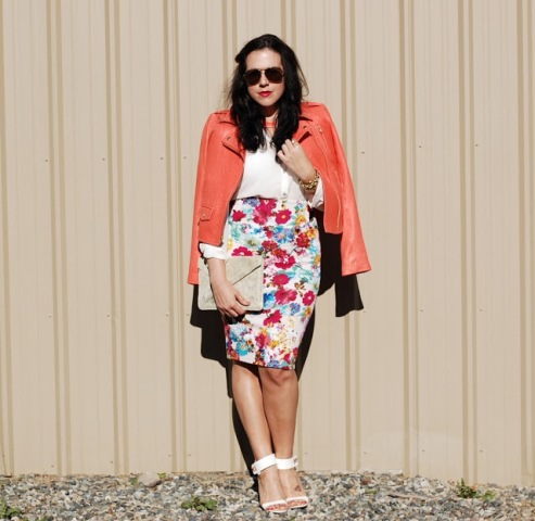 With white blouse, orange leather jacket, beige clutch and white shoes