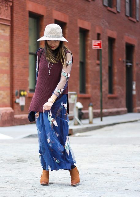 With white hat, printed maxi dress and brown boots