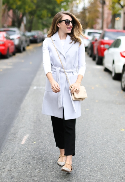 With white shirt, black wide leg trousers, beige bag and flat shoes