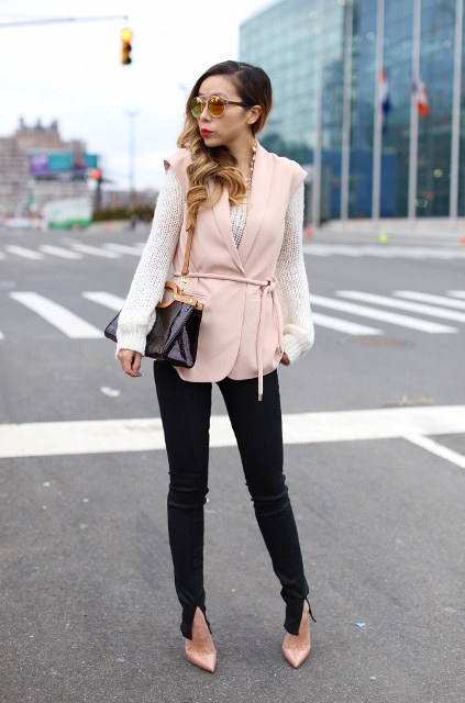 With white sweater, black pants, beige pumps and brown and black bag