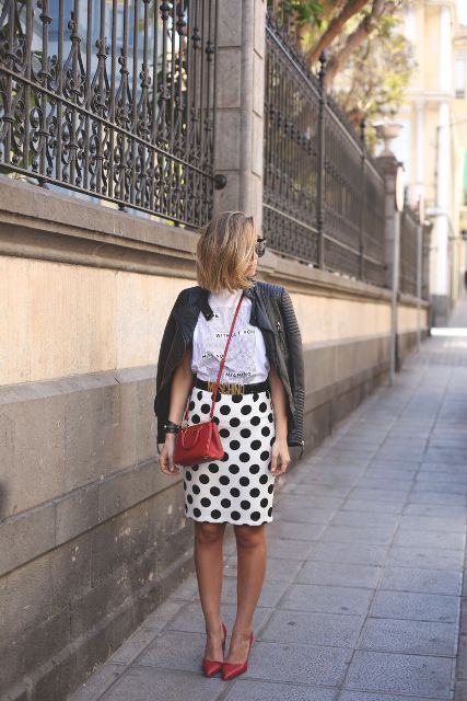 With white t-shirt, black leather jacket, red crossbody bag and red shoes