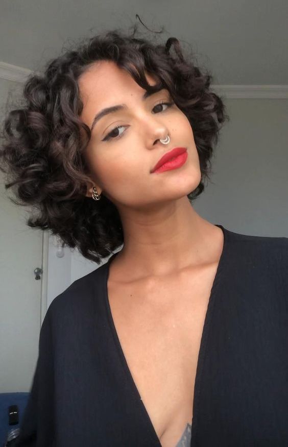 a black chin-length bob with curls is a cool and catchy idea, it looks bold and eye-catchy