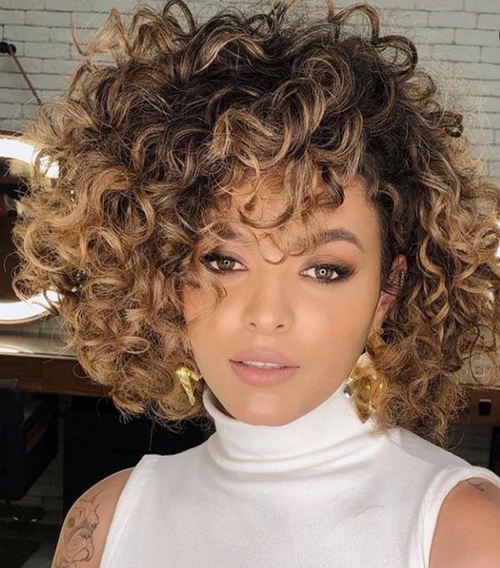 a chin-length curly bob with jaw-dropping volume and caramel balayage is a fantastic idea