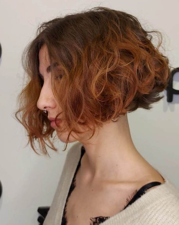 a gorgeous short curly angled bob with a darker root and a ginger ombre is a very stylish solution