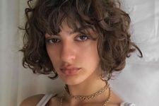 a jaw-length brunette curly bob with some volume is a catchy and chic idea to rock