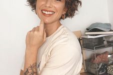 a jaw-length curly bob with copper balayage and a lot of volume is an amazingly bold idea
