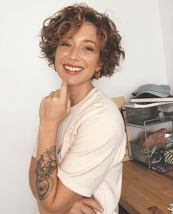 a jaw-length curly bob with copper balayage and a lot of volume is an amazingly bold idea
