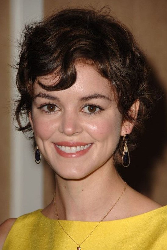 a lovely and messy brown wavy pixie with a bit of bangs is a cool and cute idea that looks Paris-inspired