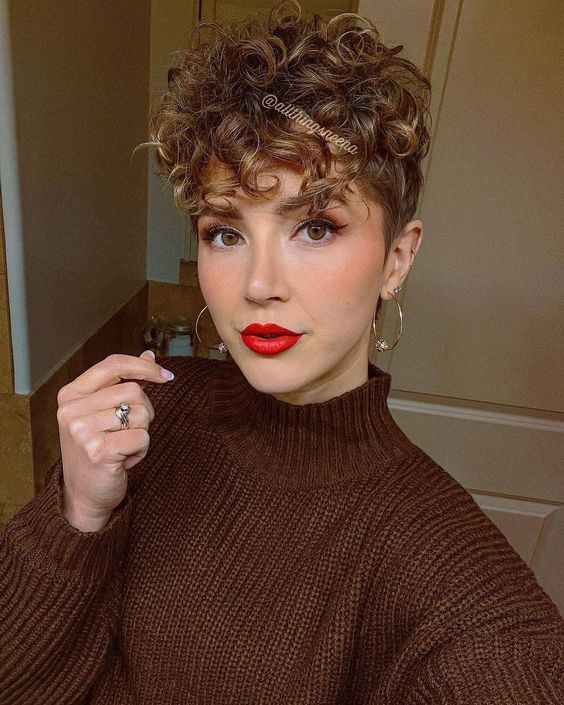 a pretty light brunette curly pixie haircut with honey blonde balayage is an amazing and bold solution