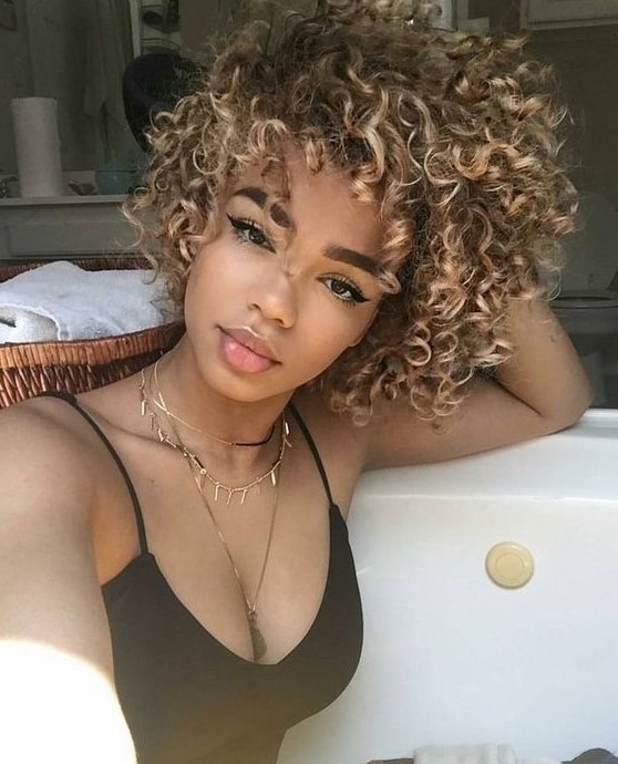 lovely natural curls with caramel blonde balayage is a beautiful and bold idea to rock
