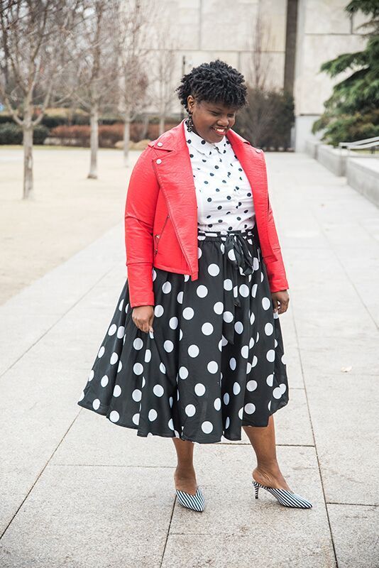 a polka dot shirt, a polka dot midi skirt, striped mules and a red leather jacket