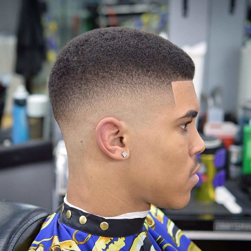 Short hair and a low taper is a fresh cut with a rounded profile to rock