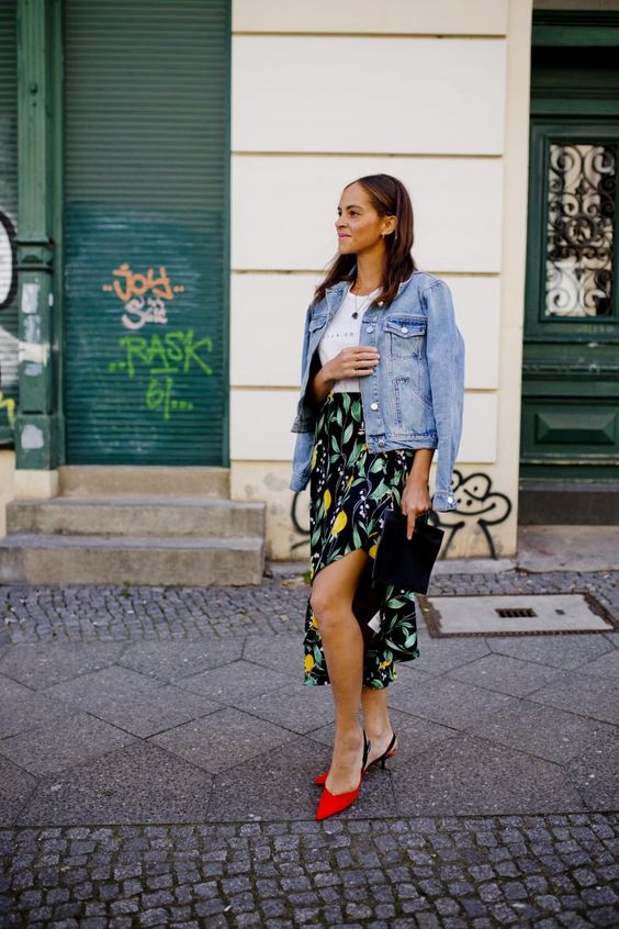 a spring look with a bright floral midi skirt with a side slit, a white tee, a denim jacket, red kitten heels