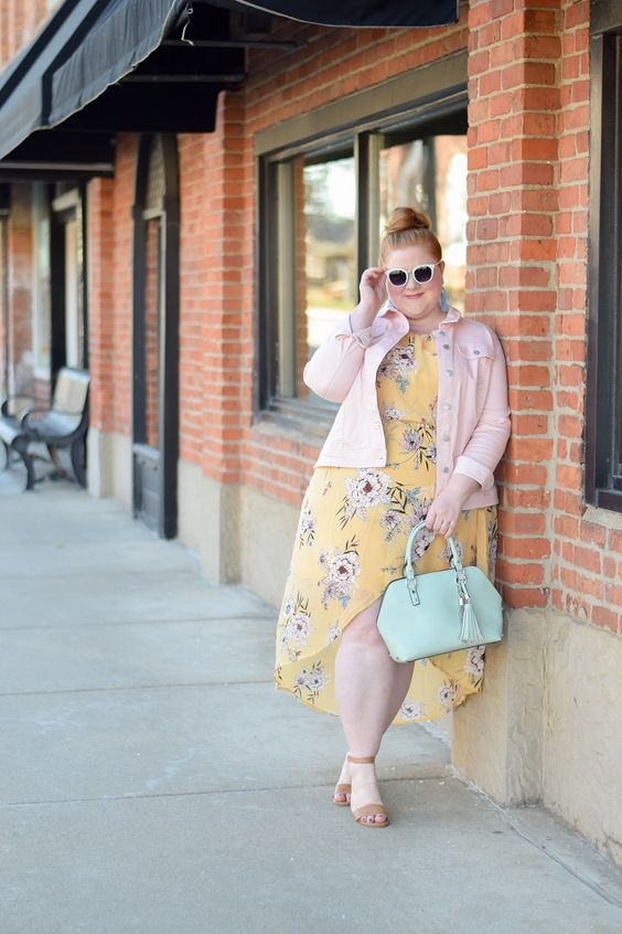 a yellow floral print midi dress with a high low skirt, nude shoes, a pink denim jacket and a mint bag