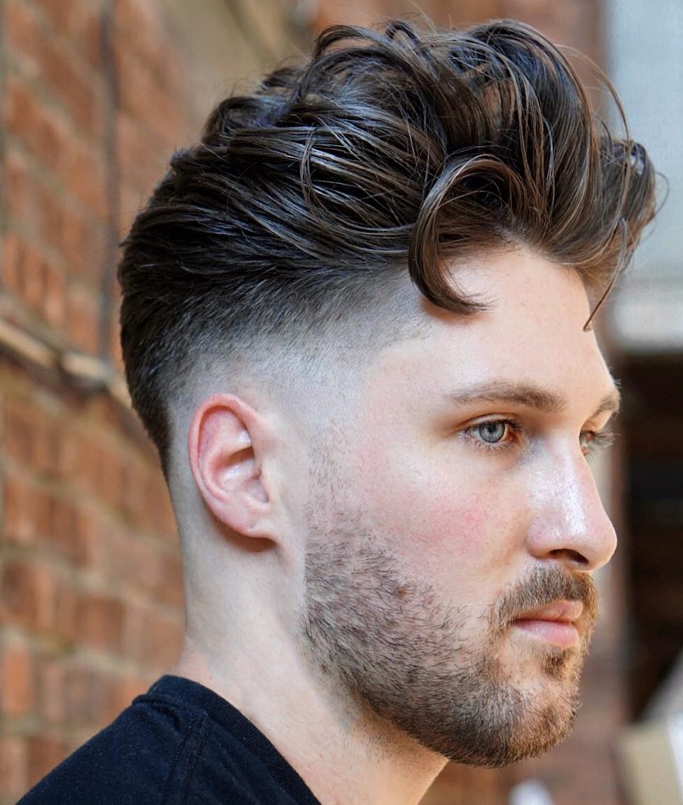 a textural pompadour fade with much volume slicked back looks very cool