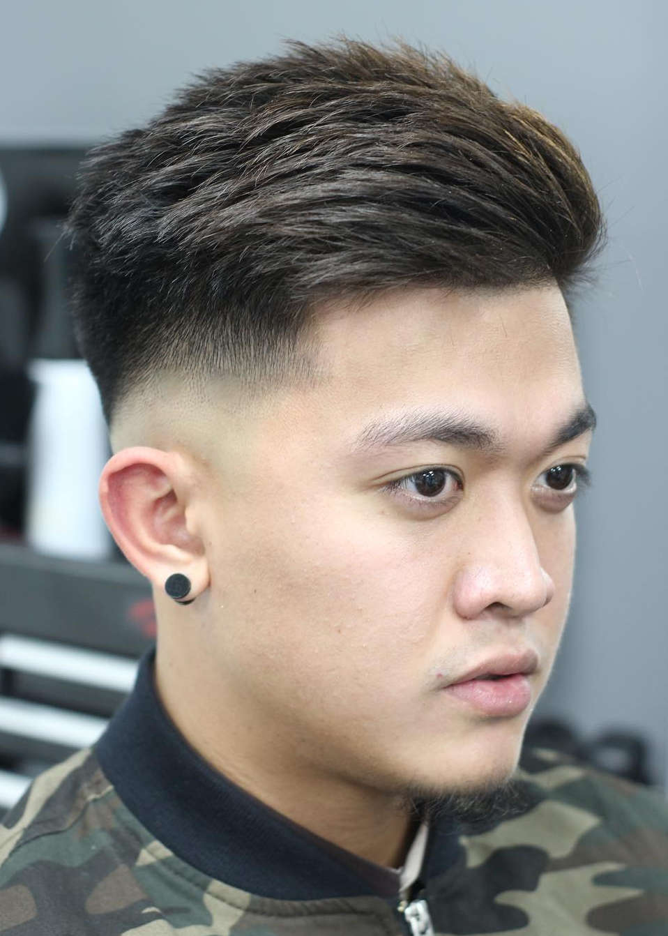 A drop fade haircut features a longer top and shorter sides that contrast