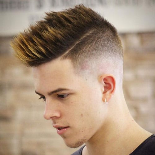 a high taper fade fohawk with highlights and styling up to make a statement