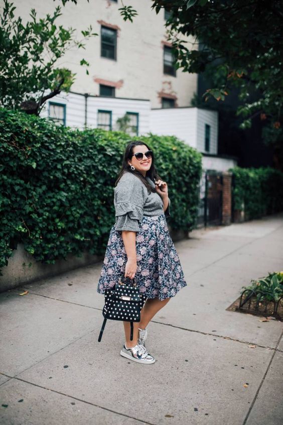 comfy look with a grey ruffle sleeve top, a floral A-line skirt, trainers and a polka dot bag