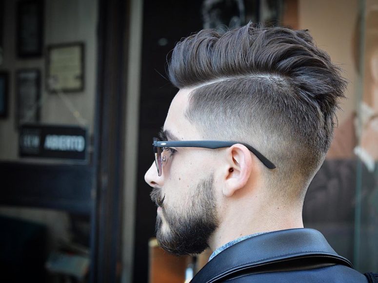 a cool messy pompadour undercut haircut styled up and a beard for a statement look