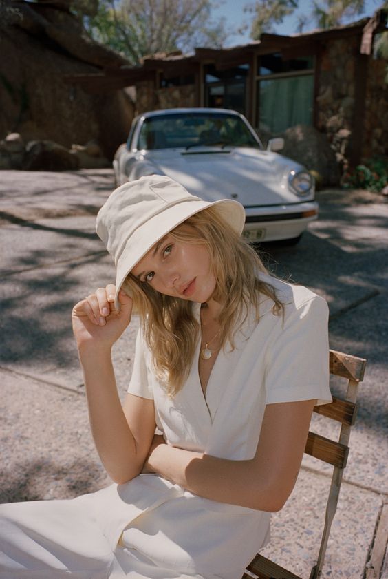 a modern spring look with a jumpsuit and a neutral bucket hat with a touch of retro