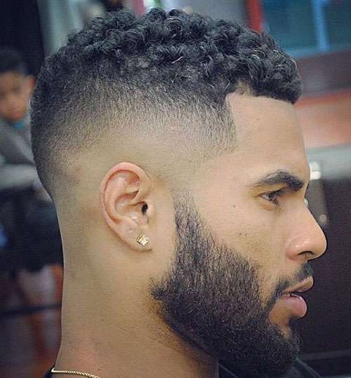 a skin fade, curls and a full beard is a stylish idea to rock right now