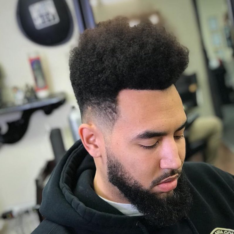 A curly high top fade is a cool idea to wear medium length and features a curly texture