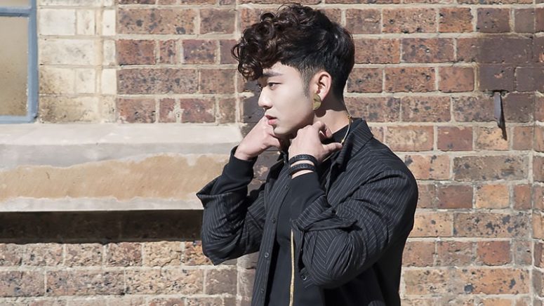 a curly pompadour features a long and curly top that contrasts the short sides