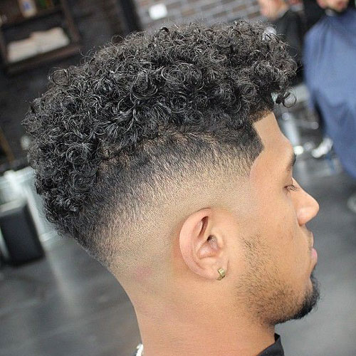 a drop fade and curls is a chic idea to show off the natural texture of your hair