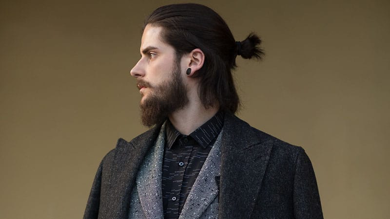 a half man bun for shorter locks and some hair down plus a beard for a bold look